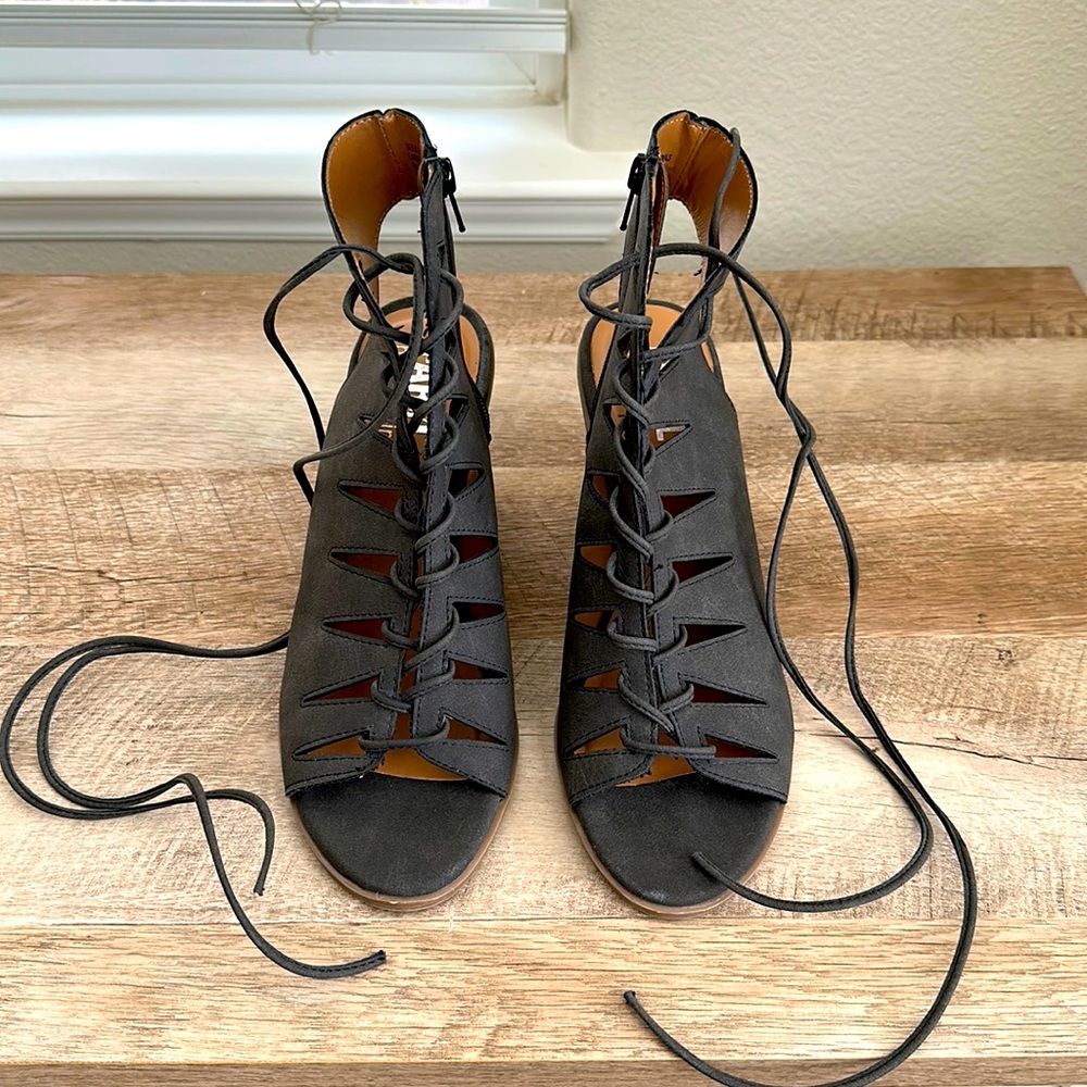 Black suade up heels that wrap around the ankle and tie